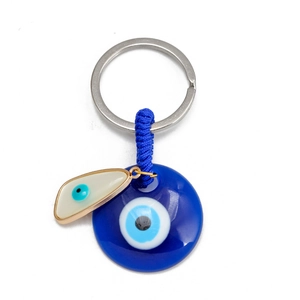 Detailed macro of Evil Eye key ring with blue glass charms and braided cord