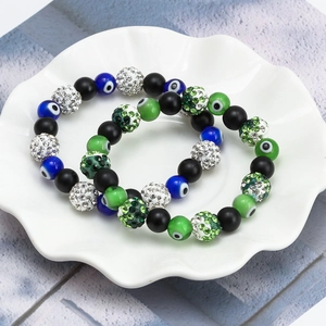 Bohemian Evil Eye beaded bracelets with crystal spheres in a ceramic floral dish