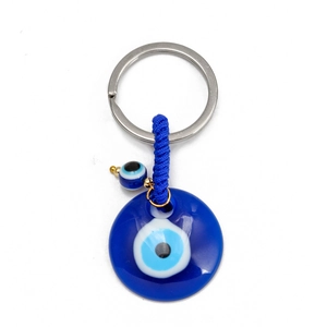 Detail of blue evil eye keychain with glass resin pendant and silver metal ring