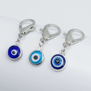 Detailed close-up of blue evil eye charms with lobster clasps for DIY jewelry making