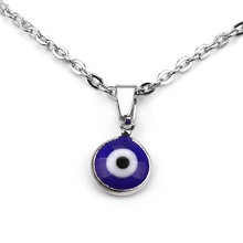 Detailed view of silver chain with Evil Eye pendant featuring deep blue center