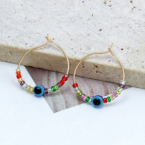 Bohemian handmade seed bead hoop earrings with evil eye charm in gold finish