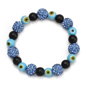 Macro shot of evil eye beads with black matte texture and blue rhinestone charms