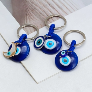 Three-piece set of golden Evil Eye horse shoe keychains with blue sapphire resin charms
