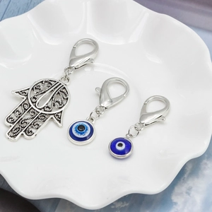 Hamsa Hand and Blue Evil Eye charms with lobster clasps in polished silver alloy metal