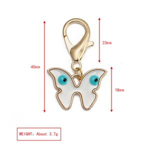 Dimensions détaillées du porte-clés papillon doré avec breloques de l'œil bleu