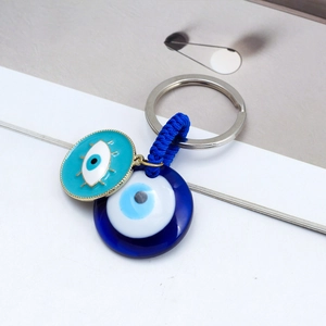 Detailed view of evil eye keychain with blue resin charms and silver metal ring