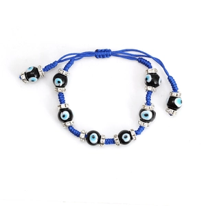 Blue braided evil eye bracelet with black beads and rhinestone spacers on white background