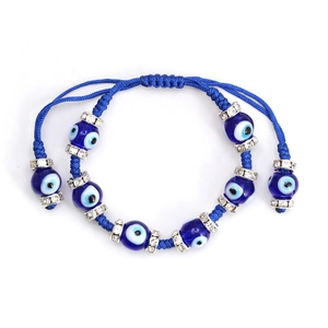 Detailed macro shot of blue woven evil eye bracelet with crystal spacers and bead ends