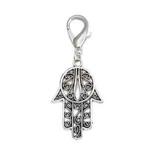 Detailed macro view of silver Hamsa Hand keychain with hollow flower patterns and lobster clasp