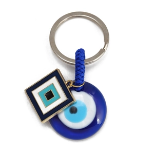 Blue Evil Eye keychain with round resin bead and geometric enamel pendant on white background