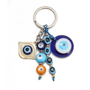 Turkish Evil Eye keychain with blue woven rope and colorful glass beads on white backdrop