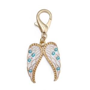 Détail de l'aile d'ange en émail blanc avec motifs œil bleu et fermoir doré