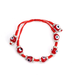 Detail of red braided Evil Eye bracelet with rhinestone spacers and adjustable cord