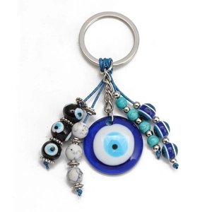 Detail of blue Evil Eye keychain with marble beads and woven blue nylon cord