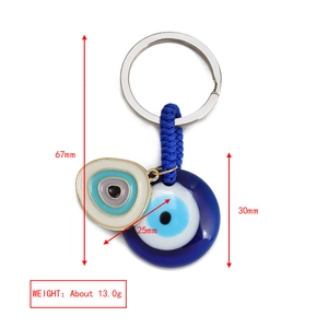 Detail showing dimensions of blue evil eye keychain with blue woven cord and silver ring