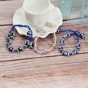 Adjustable woven Evil Eye bracelets in blue and pink with sparkling crystal spacers
