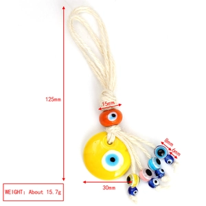 Macro view of braided evil eye pendant with size markings and yellow glass bead detail