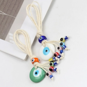 Detail of woven rope Evil Eye charms with colorful glass beads and handmade tassels