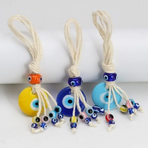 Three colorful handmade evil eye wall hangings with woven ropes and vibrant beads