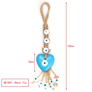 Detail showing dimensions and macro view of handmade evil eye blue glass heart ornament