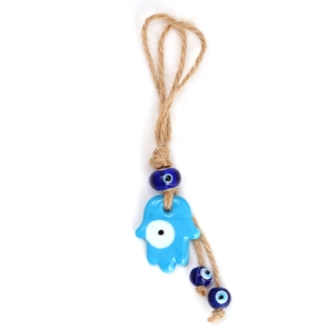 Detail of blue glass Evil Eye and Hamsa Hand pendant with natural jute rope textures