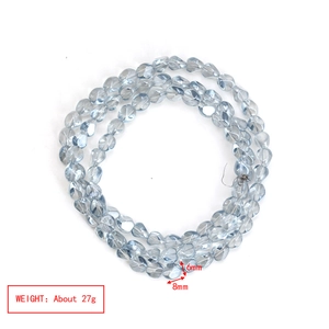 Detailed view of faceted light blue glass beads with size marking 6mm by 8mm for DIY jewelry