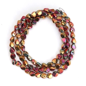 Macro shot of iridescent irregular geometric electroplated glass beads with metallic sheen