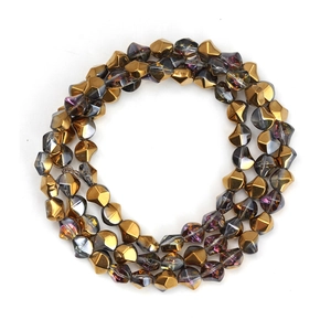 Detailed view of faceted grey-purple glass beads with metallic gold electroplating finish