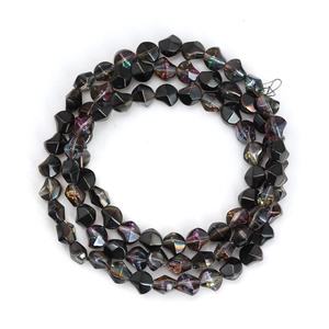 Close-up of irregular black faceted glass beads with iridescent AB coating for DIY jewelry