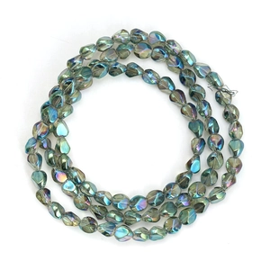 Detailed macro view of yellow iridescent irregular glass beads with AB coating finish