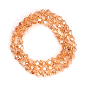 Macro detail of faceted irregular glass beads in amber orange for DIY jewelry making