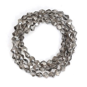 Detail of smoky gray translucent faceted glass beads in irregular geometric shapes
