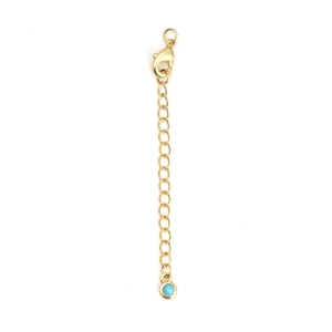Detail of gold lobster clasp chain with a turquoise-colored round bead ornament