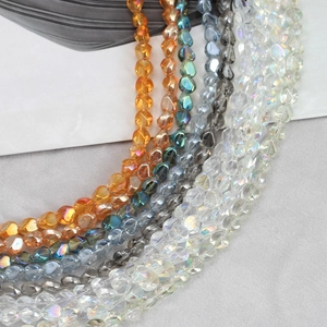 Irregular faceted crystal glass heart beads in amber, blue, grey, and iridescent colors