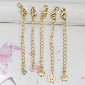 Gold-plated extender chain set with lobster clasp and assorted decorative charms