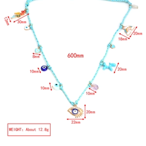 Detailed view of bohemian blue woven necklace with evil eye and rainbow charms