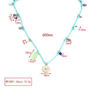 Detailed view of sky blue braided necklace with colorful bear and evil eye charm pendants