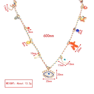 Detailed view of rainbow cord necklace with evil eye, balloon dog and heart charms