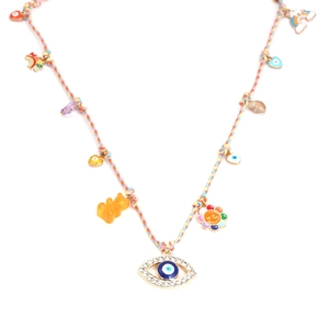 Detail of colorful woven necklace with gummy bear, rainbow and evil eye charms