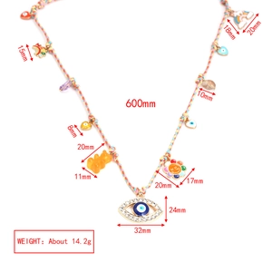 Detailed view of bohemian woven necklace with evil eye and rainbow charms showing dimensions