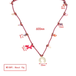 Detailed view of woven rainbow necklace with colorful charms and horseshoe pendant