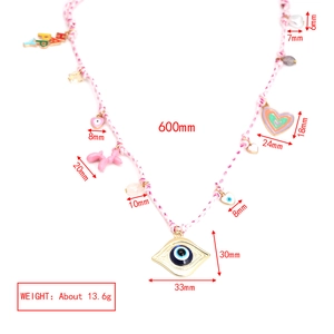 Detailed view of bohemian necklace with colorful teddy bear charms and blue eye pendants