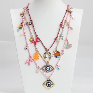 Detailed view of bohemian Y2K layered necklace with colorful resin bear and charms