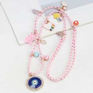 Pink woven necklace with blue evil eye pendant, gummy bear, and rainbow heart charms