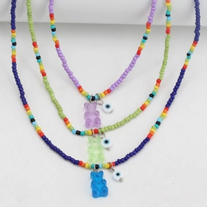 Detailed set of colorful beaded necklaces with resin gummy bear and evil eye charms
