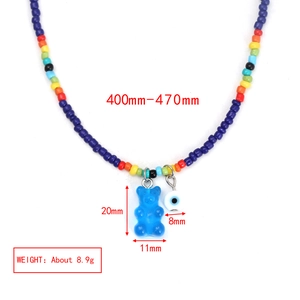 Detailed view of beaded necklace with 20mm blue gummy bear and 8mm evil eye charms
