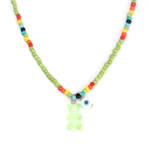 Detail of colorful seed beads with green gummy bear and evil eye pendant on a necklace