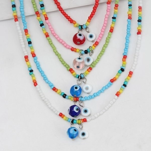 Bohemian multi-colored seed bead necklace set featuring evil eye glass pendants