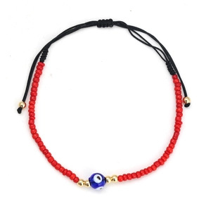 Adjustable red seed bead bracelet with blue evil eye glass and black woven cord